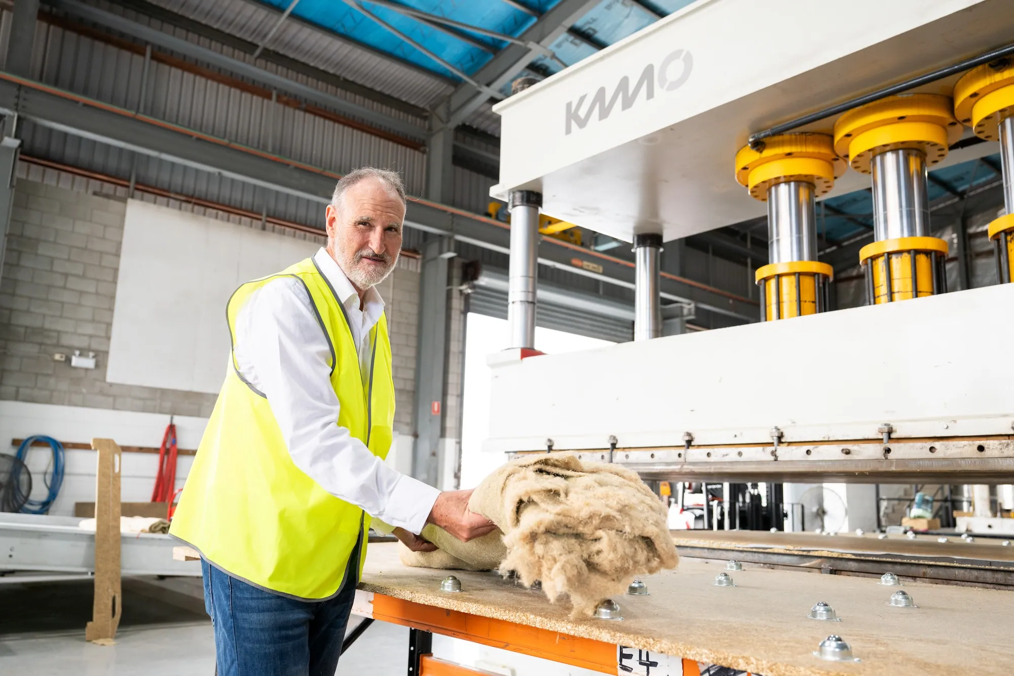 Staff at the press handling hemp material